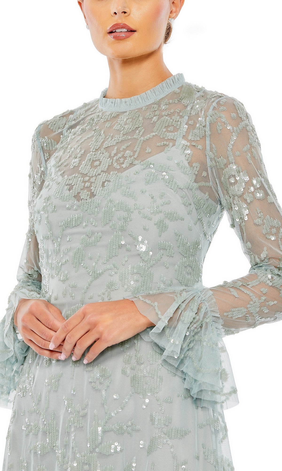 A woman is shown from the waist up wearing the Mac Duggal 9139 short party dress, a light blue mini cocktail dress with long lace sleeves, sequin embellishments, and ruffled cuffs.